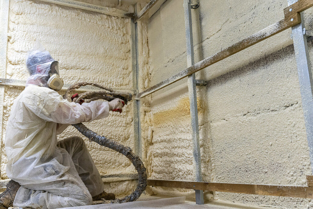 Man installing spray foam insulation