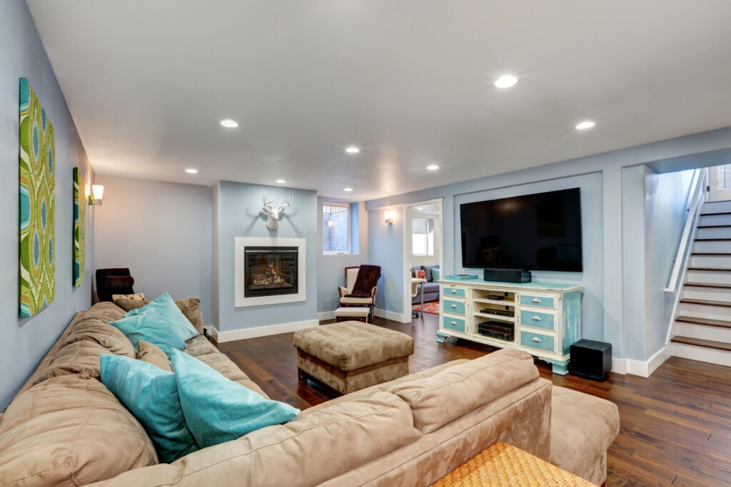 A finished basement with blue walls. 